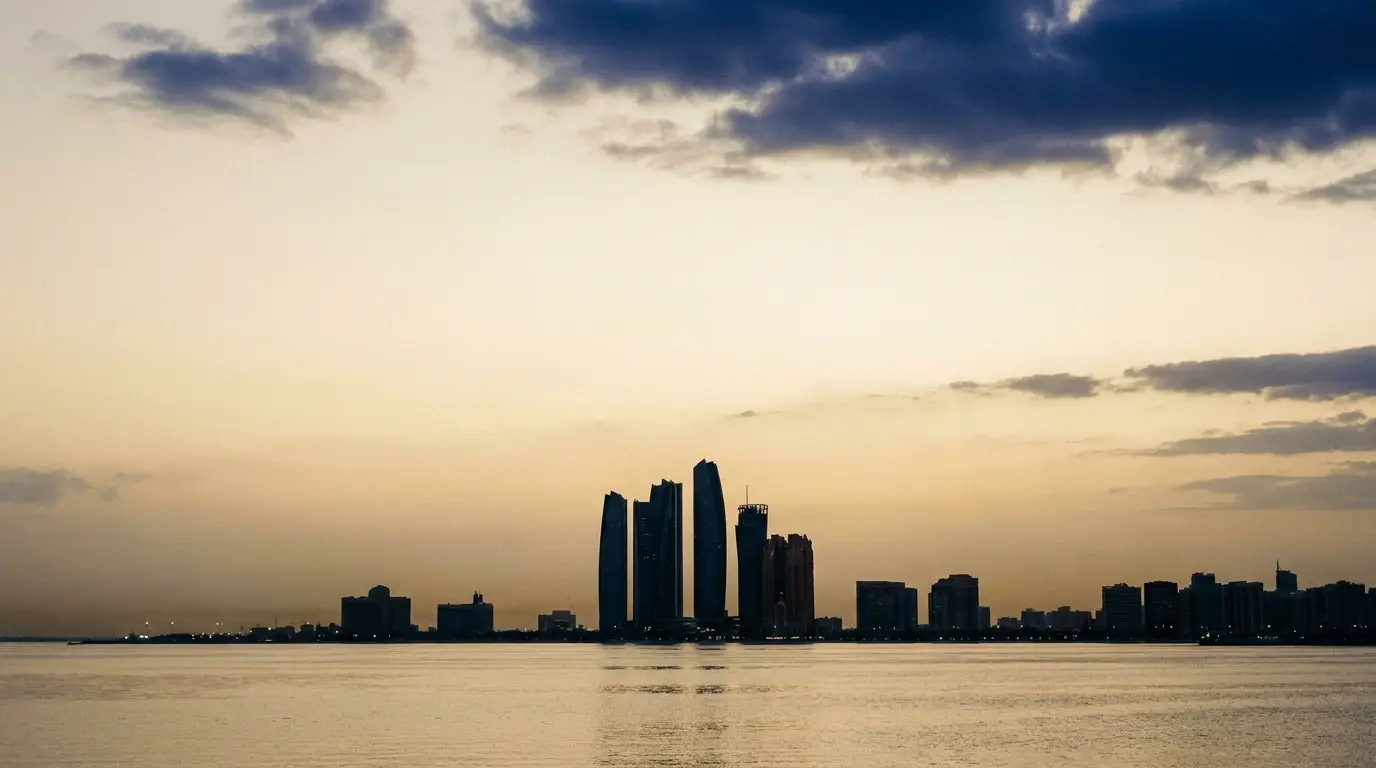 The Abu Dhabi Corniche skyline across the water at dusk
