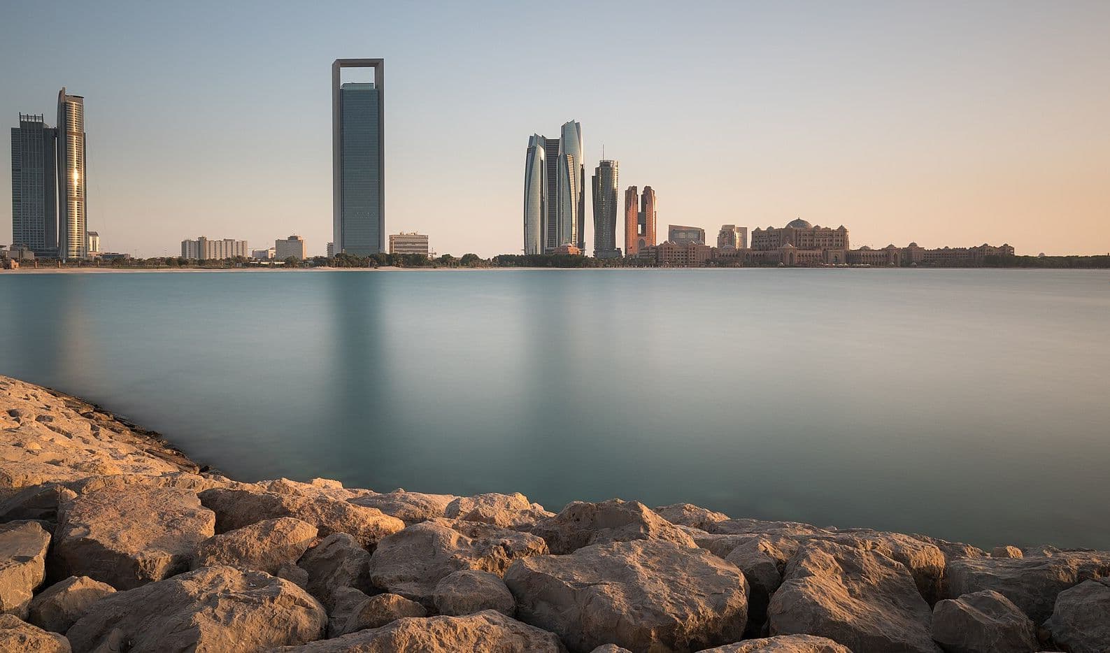 Abu Dhabi skyline at sunset across the water